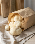 Fresh lion's mane mushrooms in a plain kraft paper bag